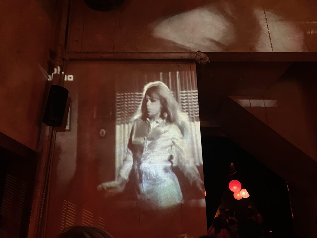 old movie playing in a dive bar