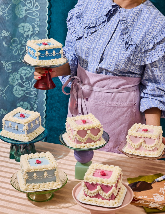 a woman baker with 5 mini vintage cakes in different colors 